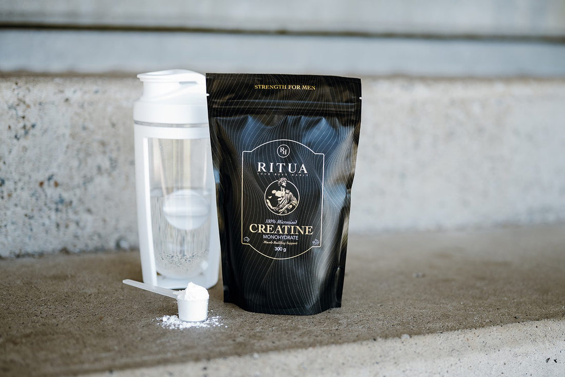 Pouch of Ritua Creatine Monohydrate beside a shaker and a scoop of creatine powder