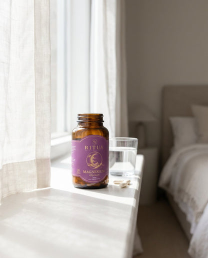 Ritua Magnesium Glycinate on bedside table with water