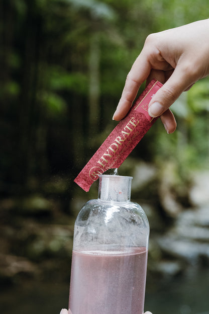 Ritua Hydrate Berry being poured into the 500ml Ritua drink bottle outdoors