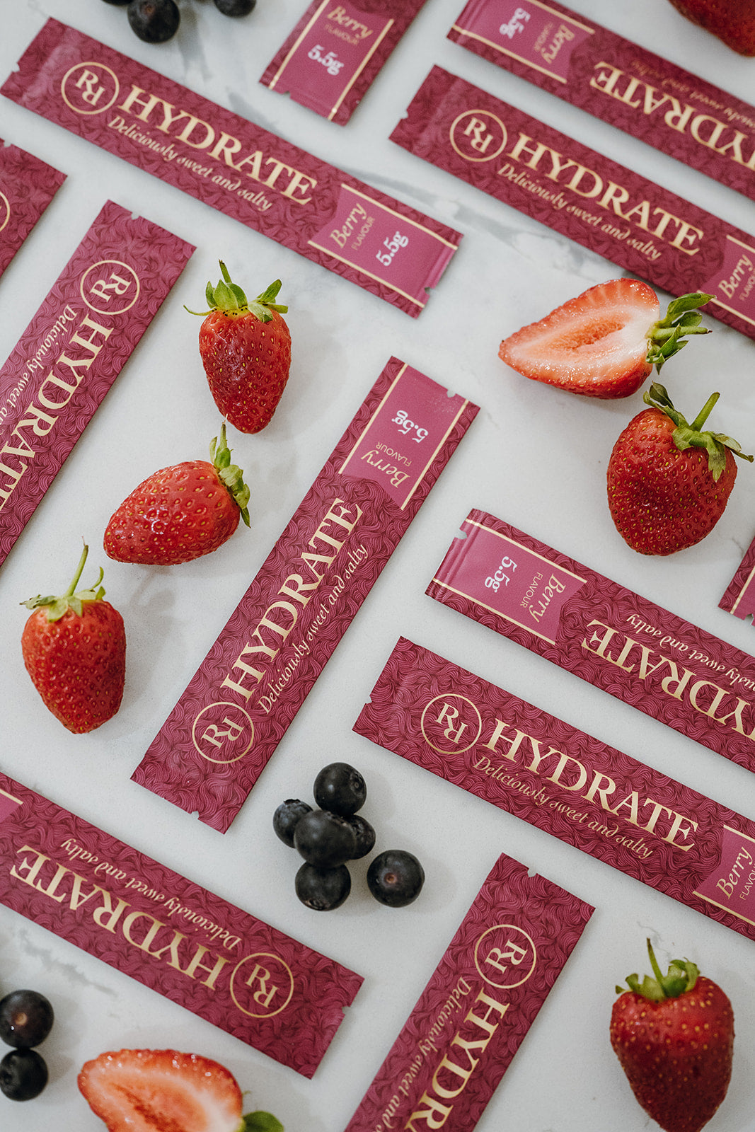 Ritua Hydrate Berry sachets with fresh strawberries and blueberries