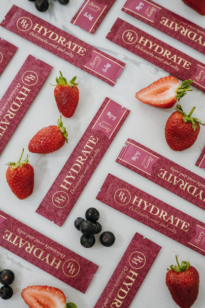 Ritua Hydrate Berry sachets with fresh strawberries and blueberries