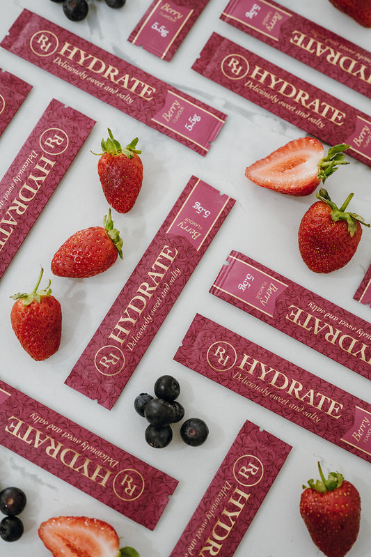 Ritua Hydrate Berry sachets with fresh strawberries and blueberries